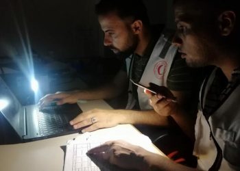 These are the kind of photos Amr used to take as a media officer for the Palestinian Red Crescent, whose volunteers shown here keep working even through constant power outages. Photo: Amr Ali/Palestinian Red Crescent Society